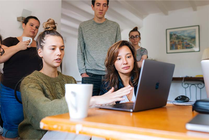 group-looking-at-laptop-together