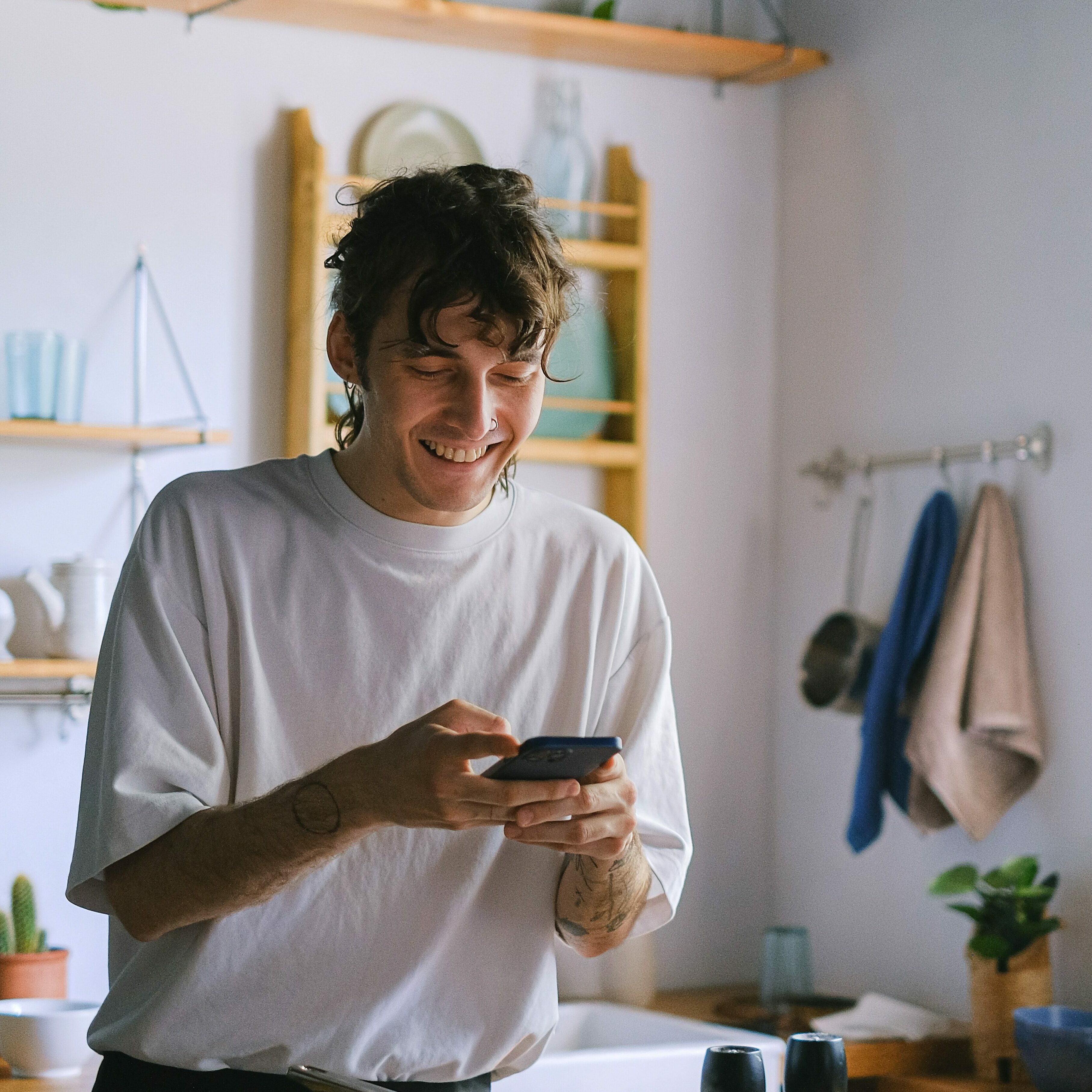 man-looking-at-phone-smiling